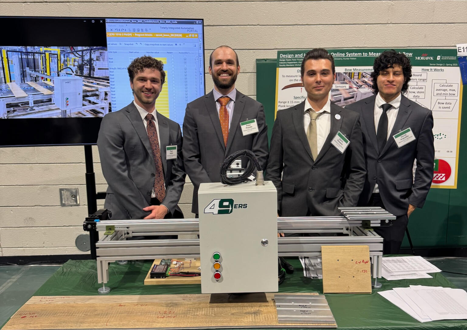 Paul Adair and senior design team with the Mohawk plank bow measurement system at the UNC Charlotte senior design expo Paul Adair and senior design team with the Mohawk plank bow measurement system at the UNC Charlotte senior design expo